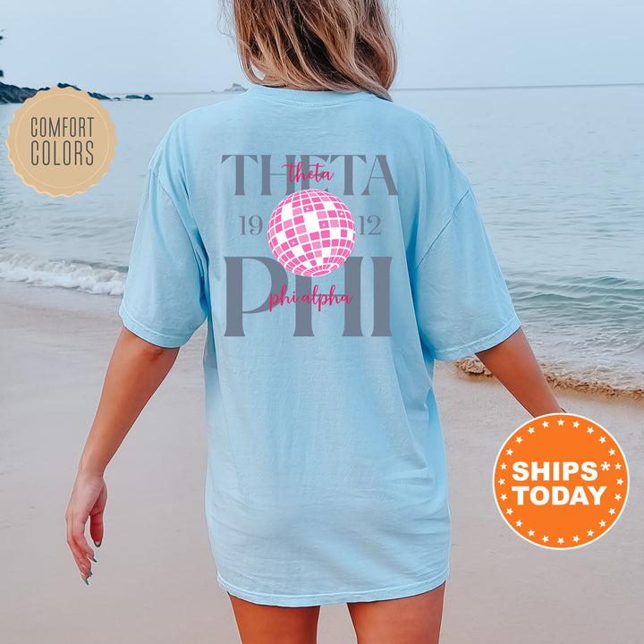 a woman walking on the beach with a t - shirt on