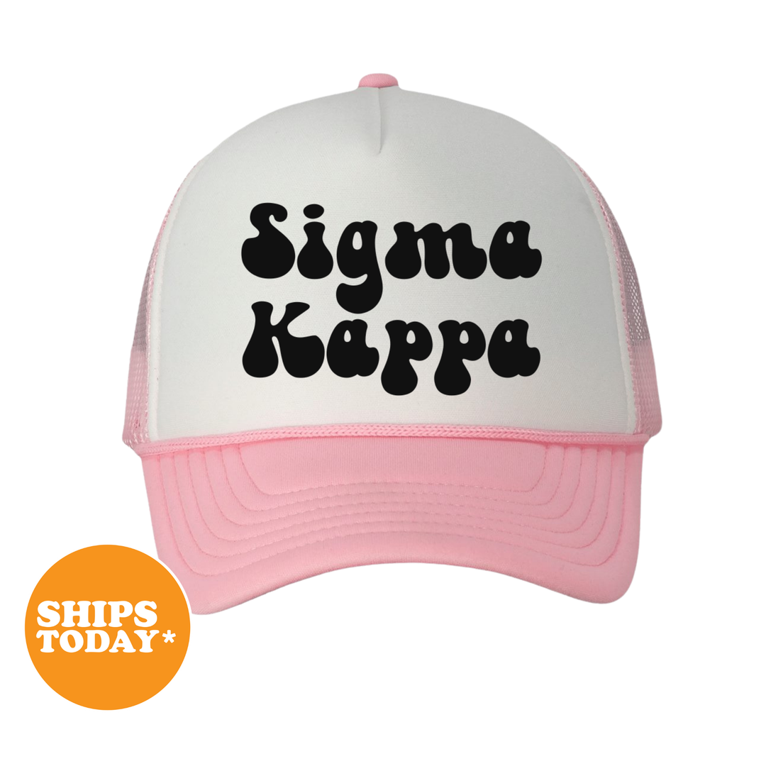A white and pink trucker hat with the text "Sigma Kappa" printed on it.