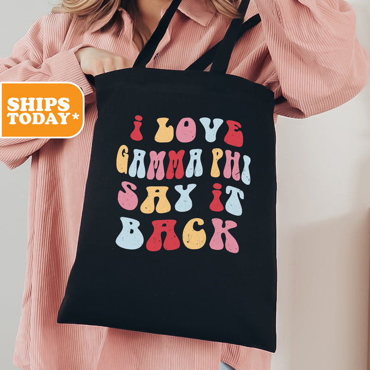 a woman holding a black shopping bag that says i love gummy pill sky it