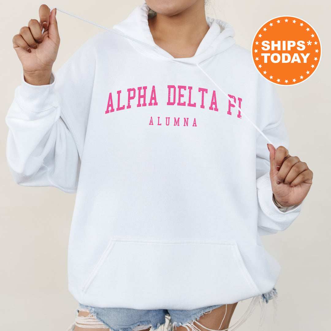 a woman wearing a white hoodie with pink letters