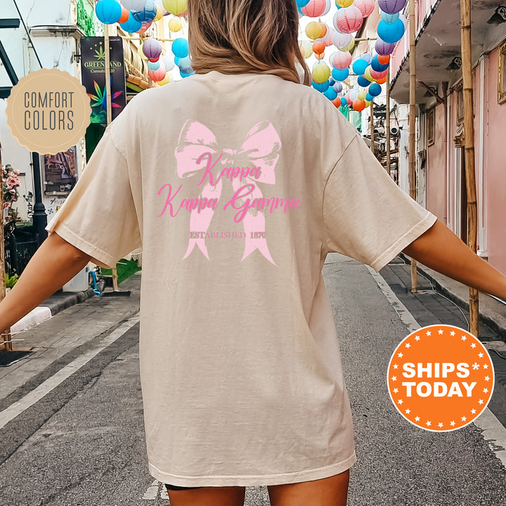 a woman walking down a street with a pink bow on her shirt