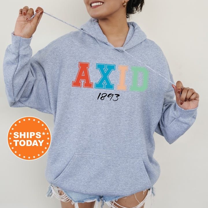 a woman wearing a blue hoodie with the word axid printed on it