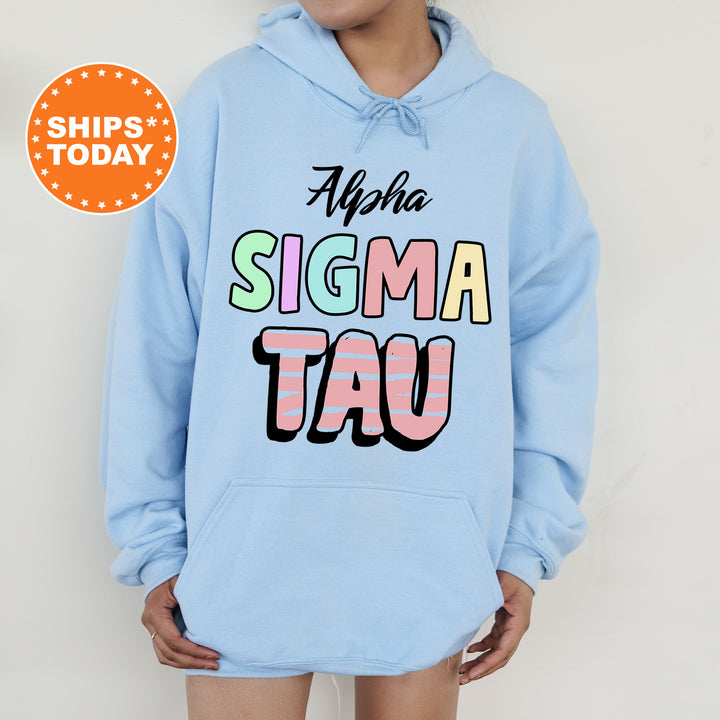 a woman wearing a light blue hoodie with the words aloha sigm