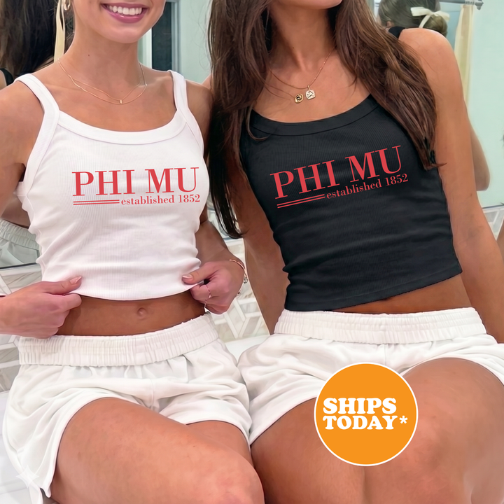 Two women wearing tank tops with the text "PHI MU established 1852" are sitting next to each other.