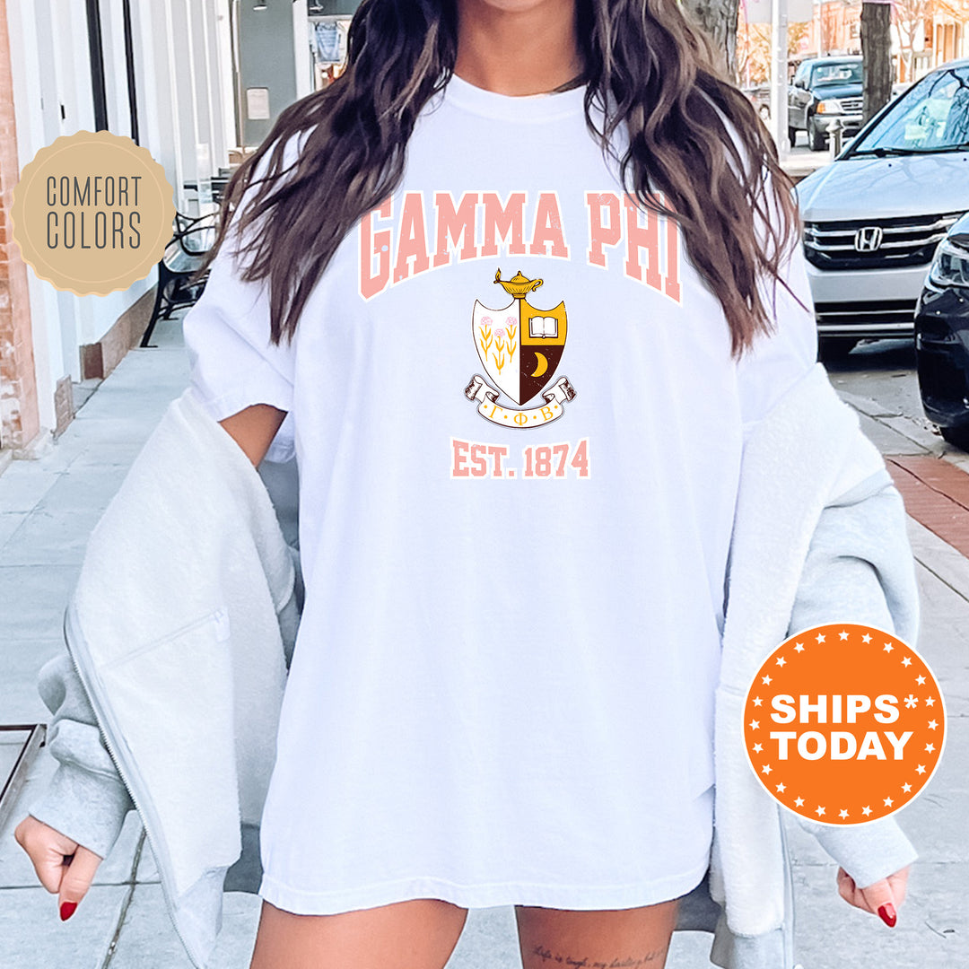 a woman wearing a white shirt with the words gama phi est 1974 on it