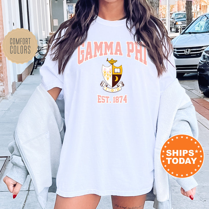 a woman wearing a white shirt with the words gama phi est 1974 on it
