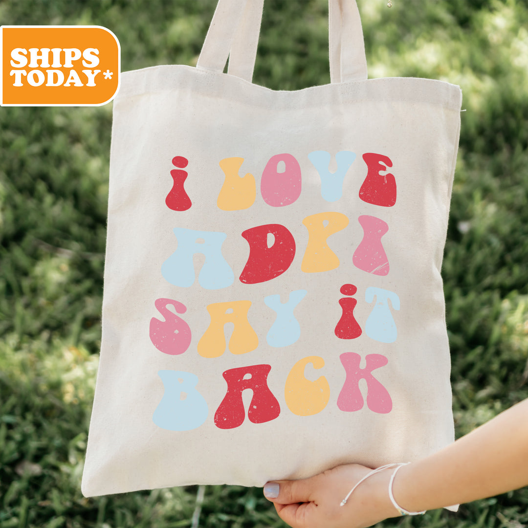 a person holding a tote bag with a design on it