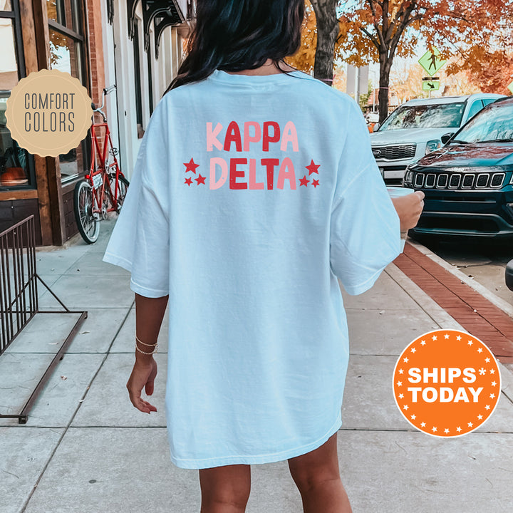 a woman is walking down the sidewalk wearing a t - shirt that says kapa