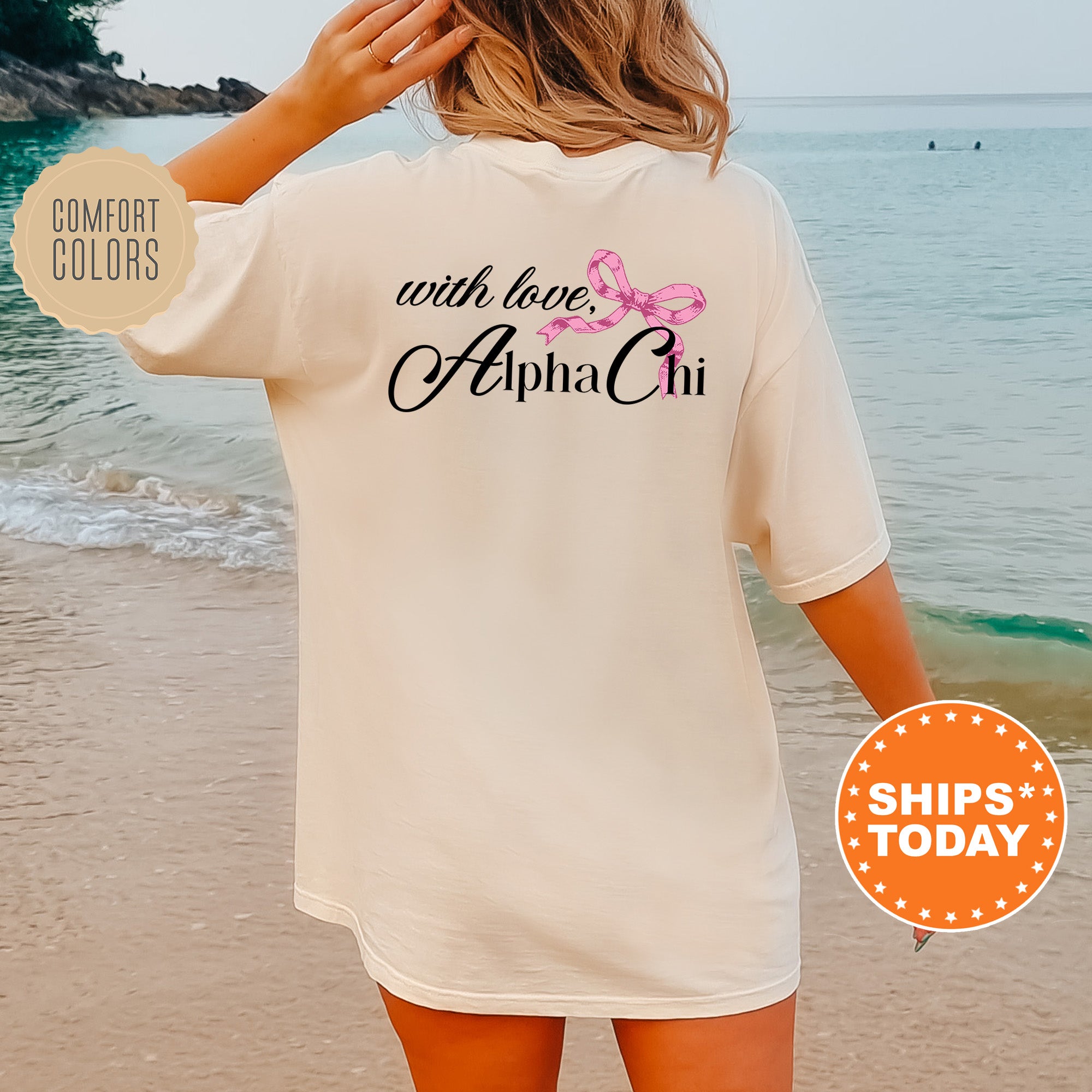 a woman standing on a beach wearing a white shirt