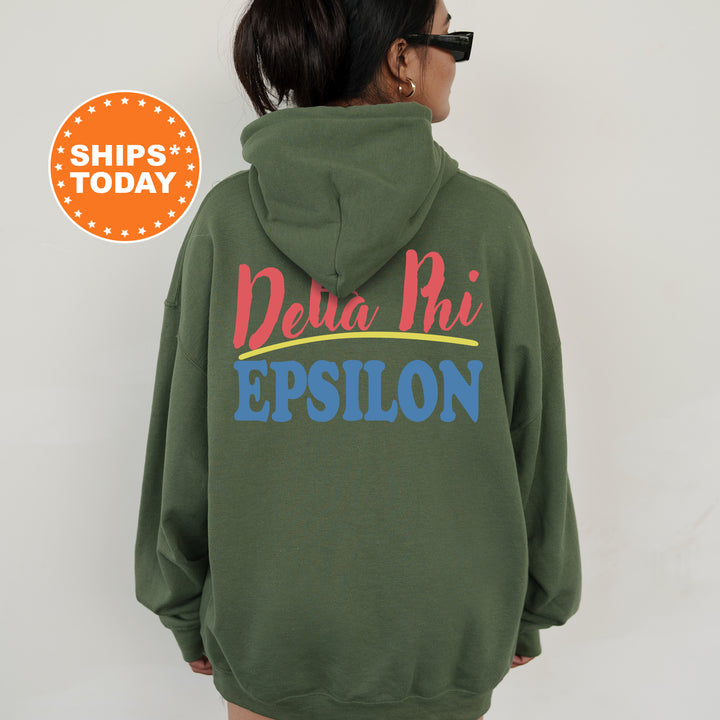 A person wearing a green hoodie with the Delta Phi Epson logo printed on it.