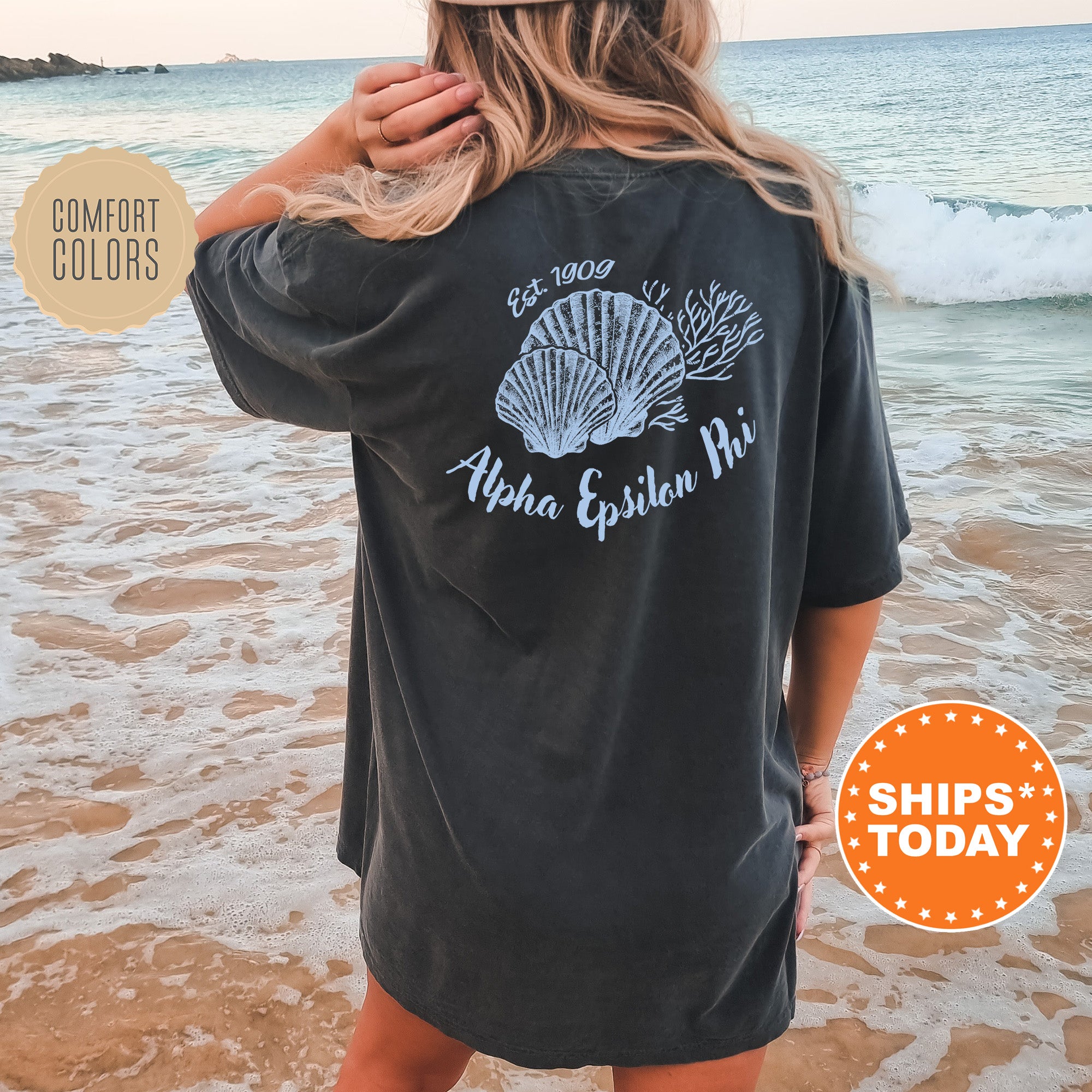 A woman wearing a black t-shirt with a graphic design of a shell and the text 