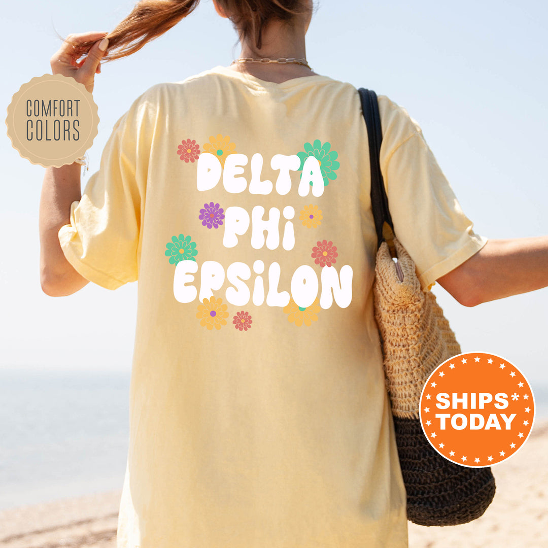 a woman walking on the beach with a t - shirt that says delta phi ep