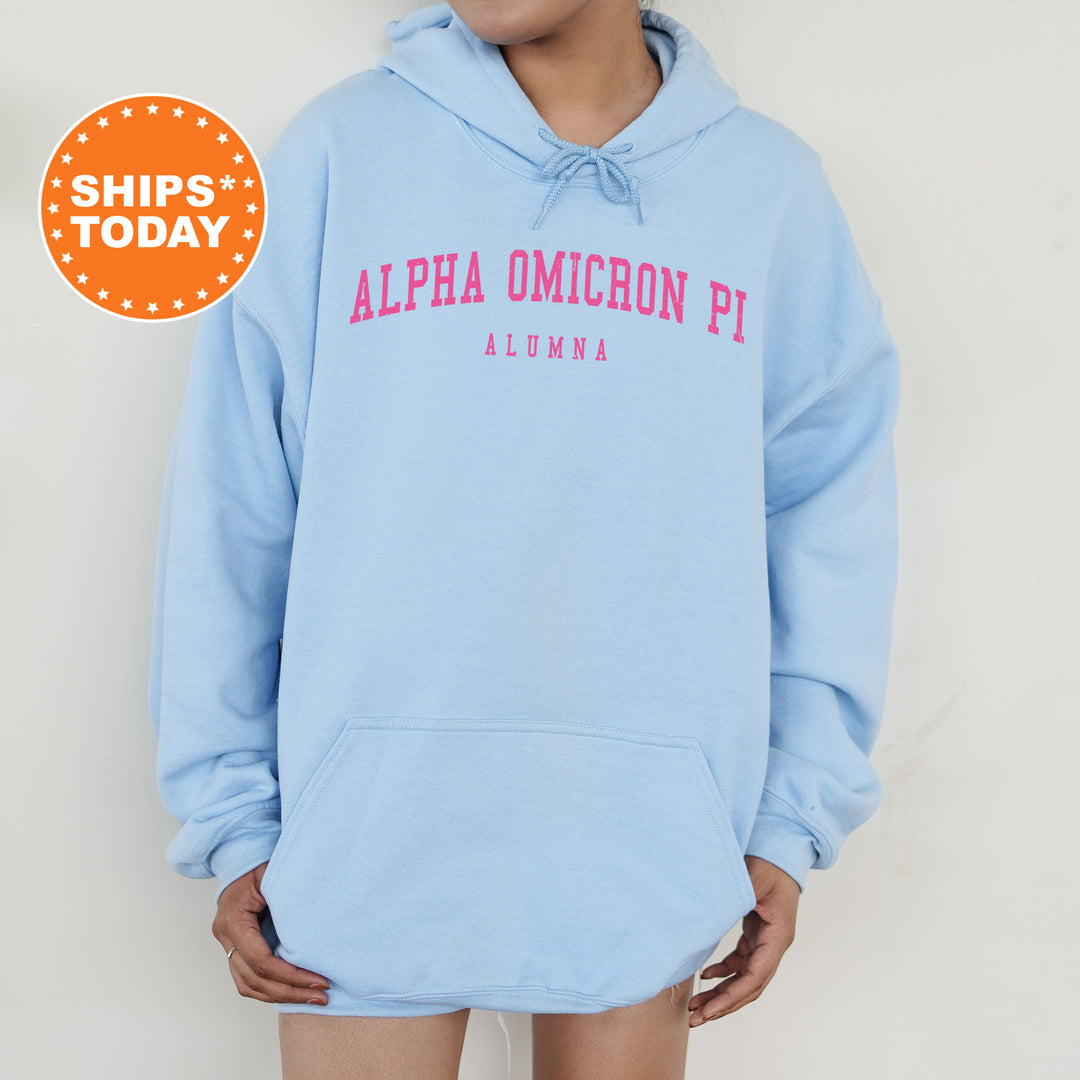 a woman wearing a blue hoodie with pink letters on it