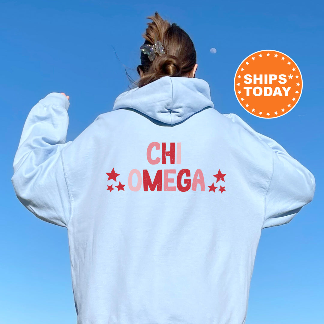 a woman wearing a white hoodie with the words chi omega printed on it