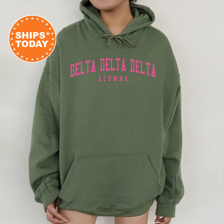 a woman wearing a green delta delta hoodie