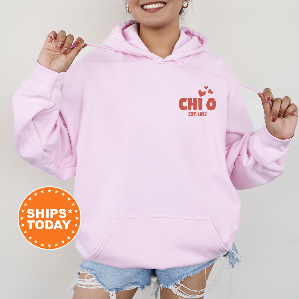 a woman wearing a pink hoodie with the words chio on it