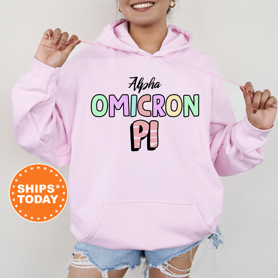 a woman wearing a pink hoodie with the word omicron on it