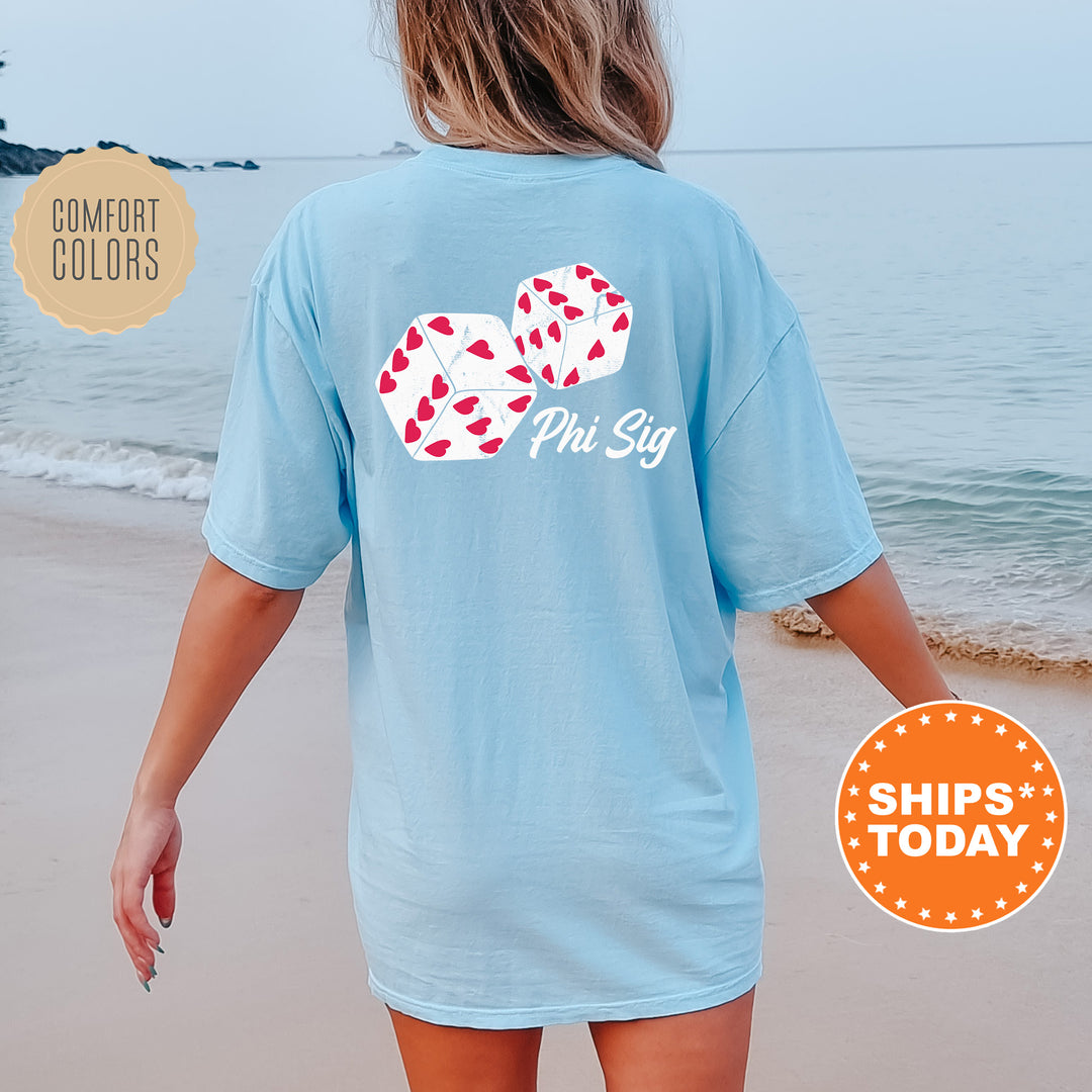 a woman walking on the beach wearing a blue shirt