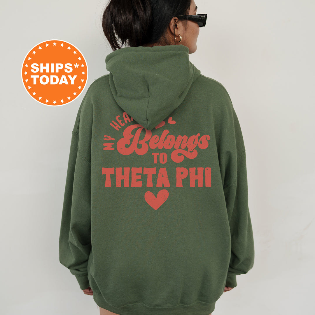 a woman wearing a green hoodie that says, we are belongs to the phi