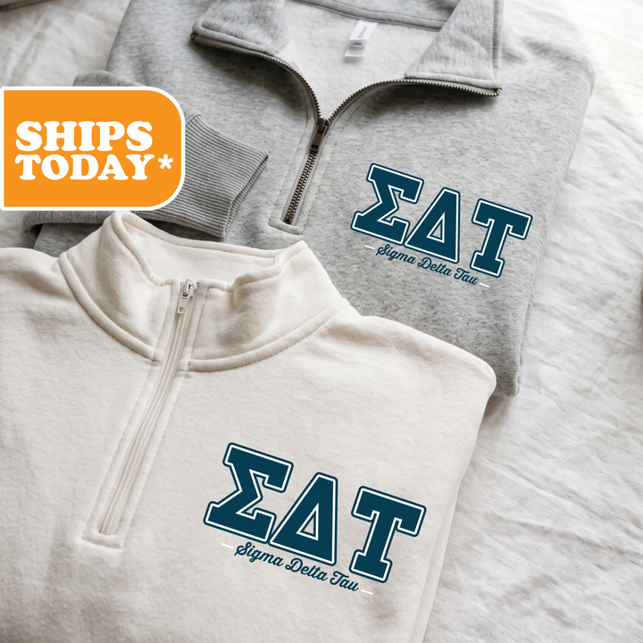 Two gray sweatshirts with the Sigma Delta Tau logo printed on them, along with a gray sweatshirt with a zipper and a white sweatshirt with a zipper.