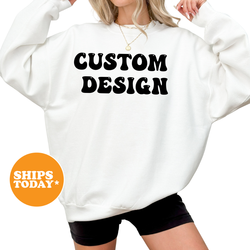 A woman wearing a white sweatshirt with the text "CUSTOM DESIGN" printed on it.