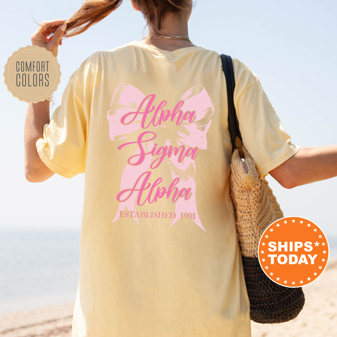 a woman walking on the beach with a pink shirt on