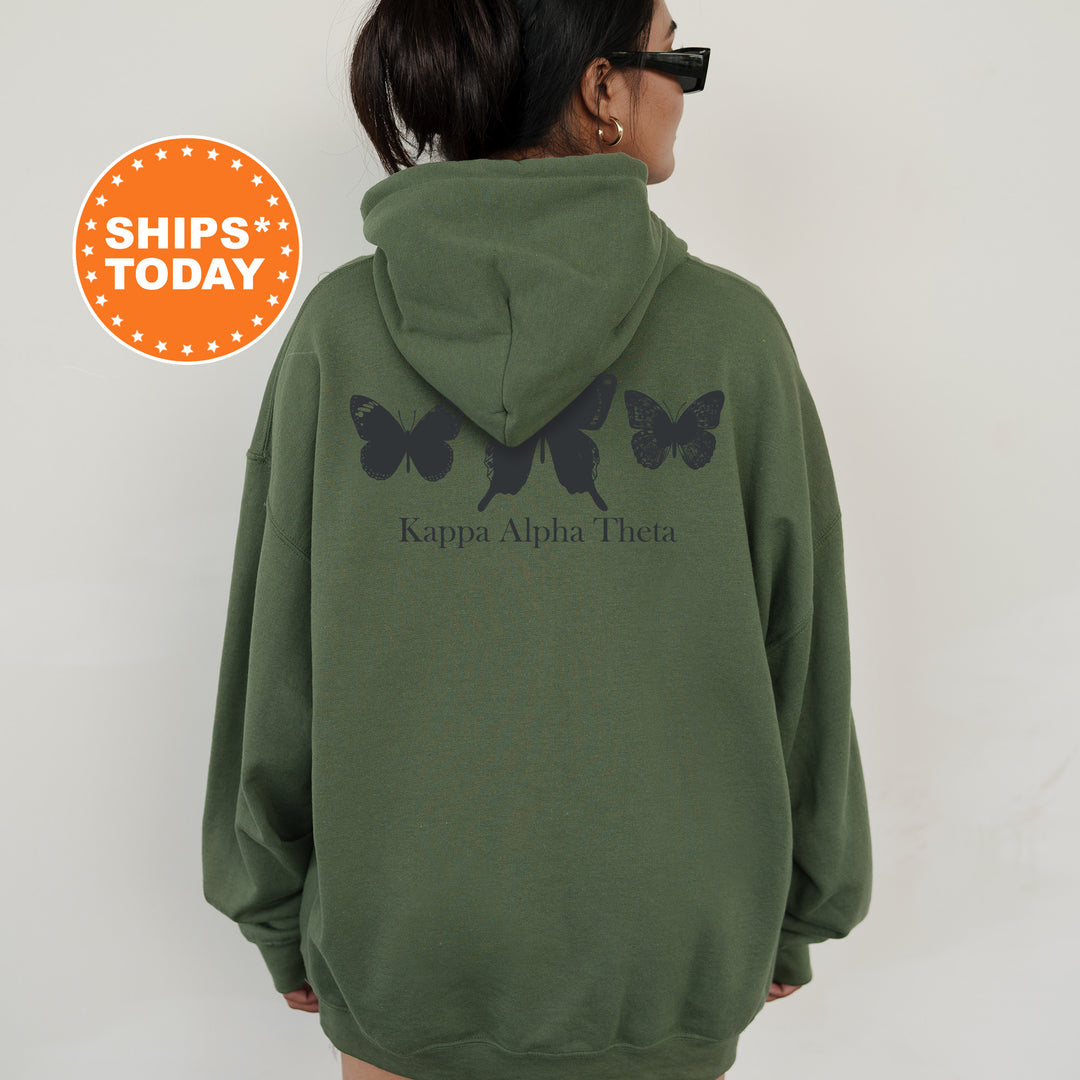 a woman wearing a green hoodie with black butterflies on it