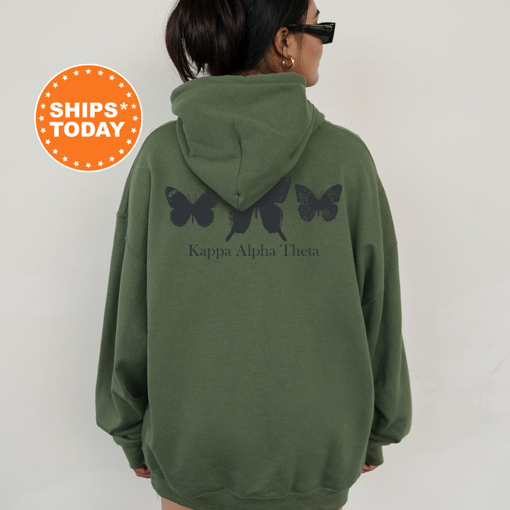 a woman wearing a green hoodie with black butterflies on it