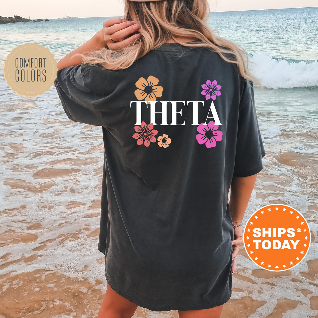 a woman standing on a beach wearing a black shirt
