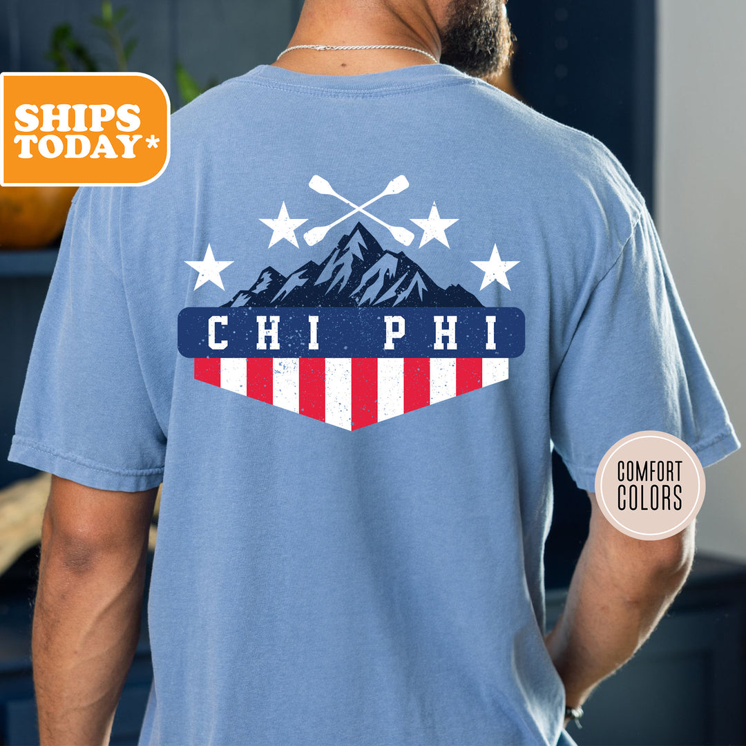 a man wearing a blue shirt with a mountain and stars on it