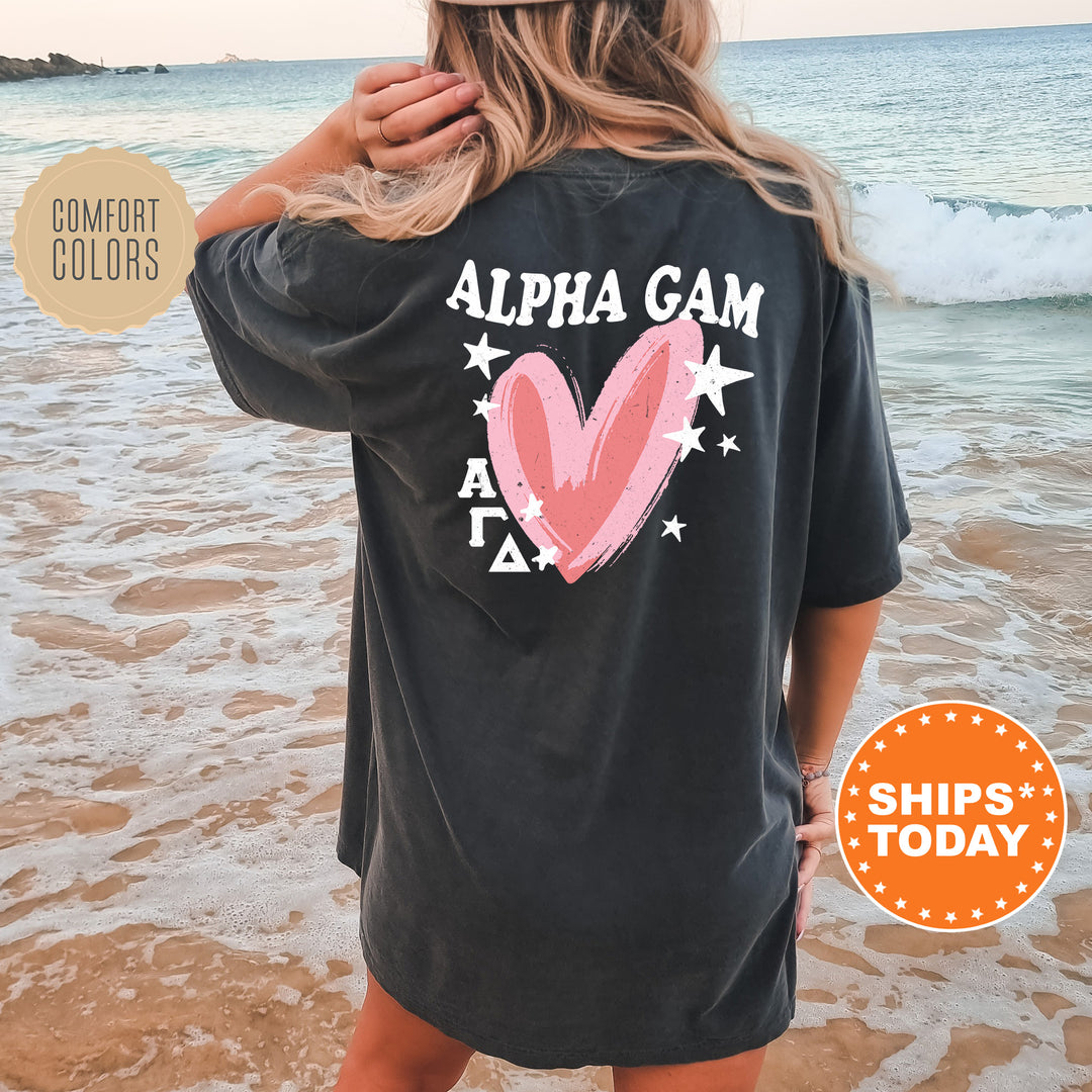 a woman wearing a black shirt with a pink heart on it