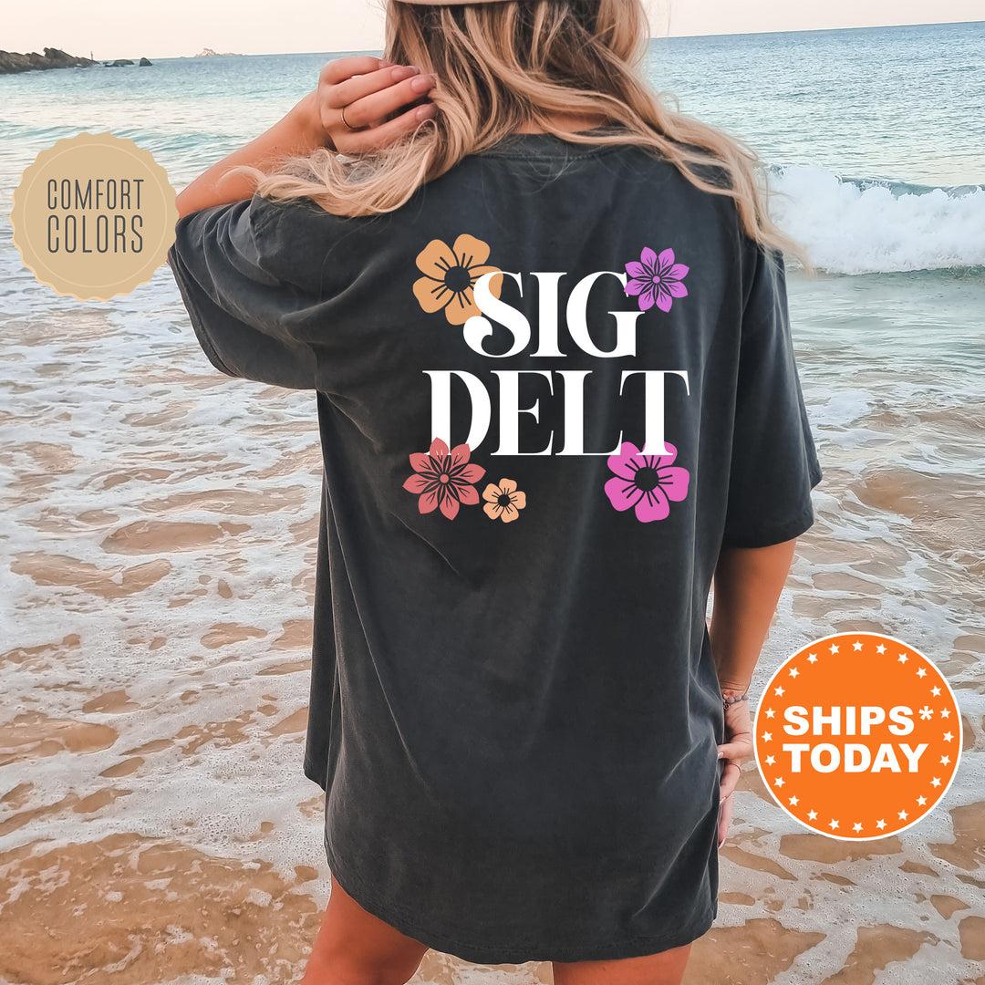a woman standing on a beach wearing a black shirt