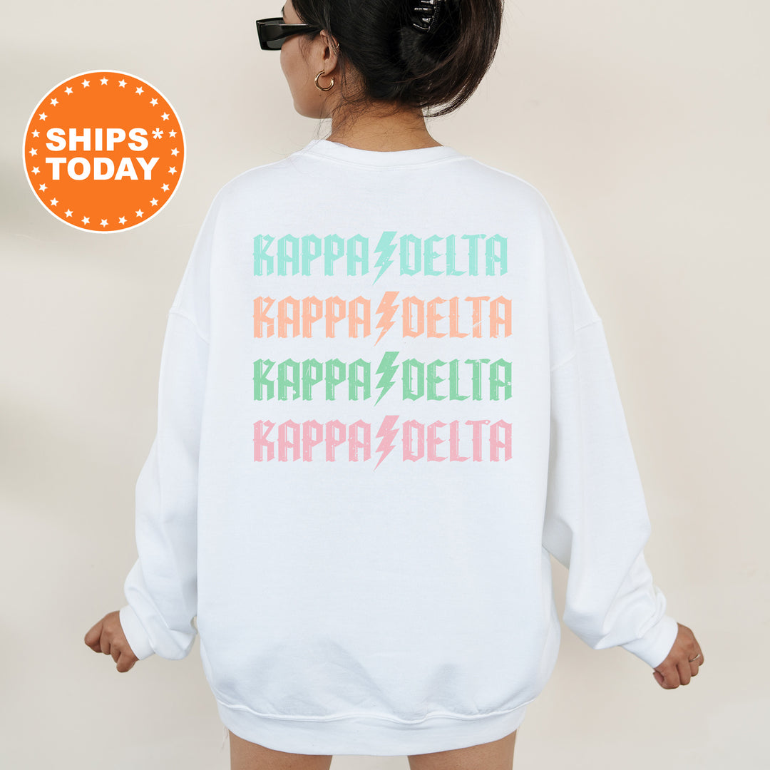a woman wearing a white sweatshirt with colorful letters on it
