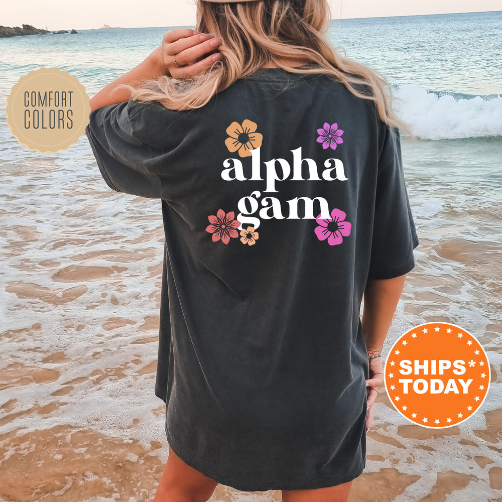 a woman standing on a beach wearing a black shirt