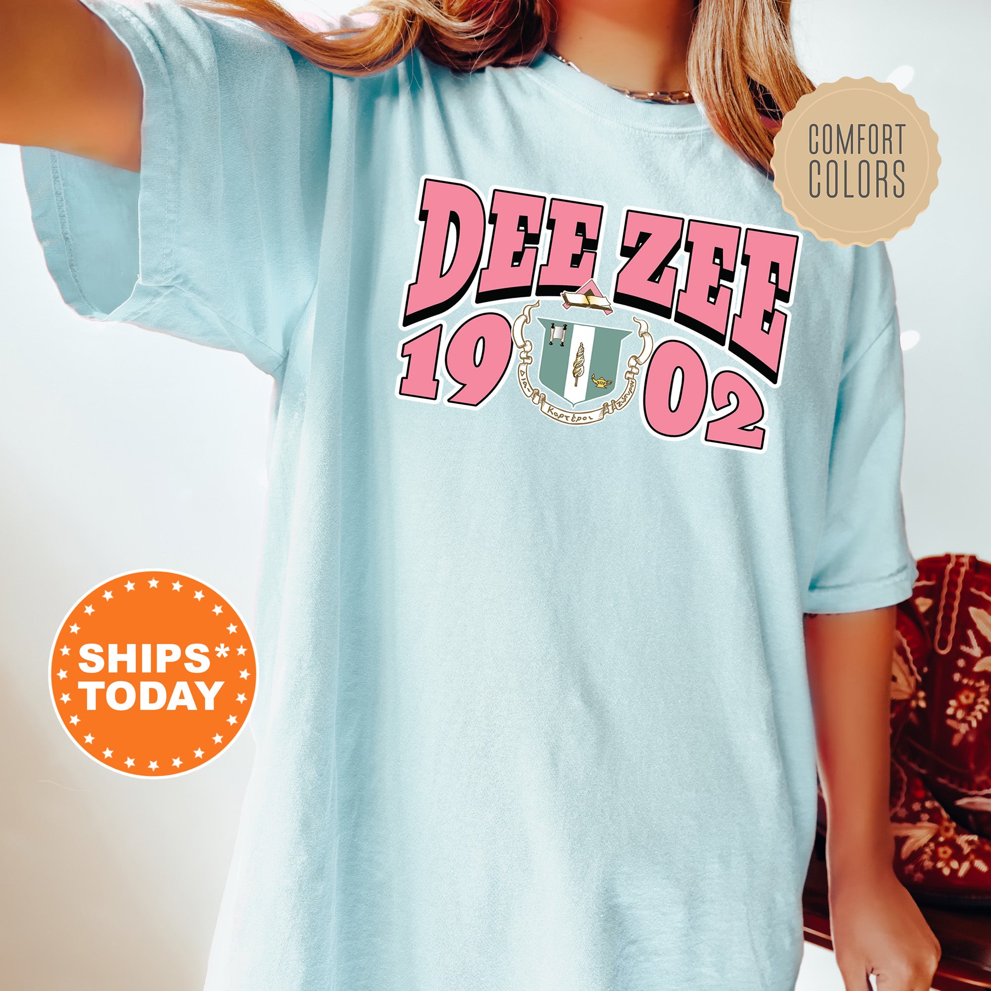 a woman wearing a blue tee shirt with the words dee zeee on it
