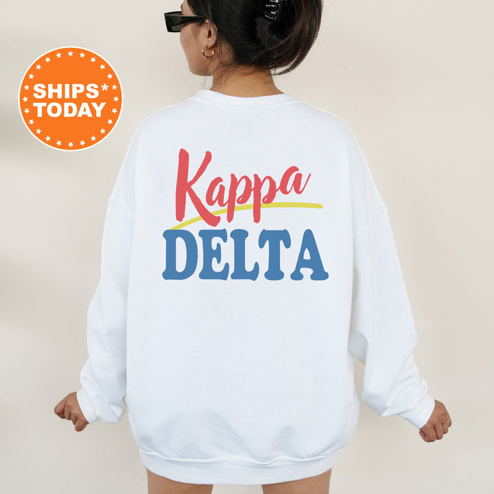 A person wearing a white sweatshirt with the text "Kappa Delta" printed on it.