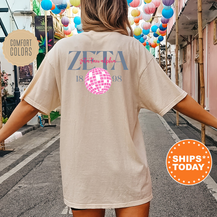 a woman is walking down the street with a t - shirt on