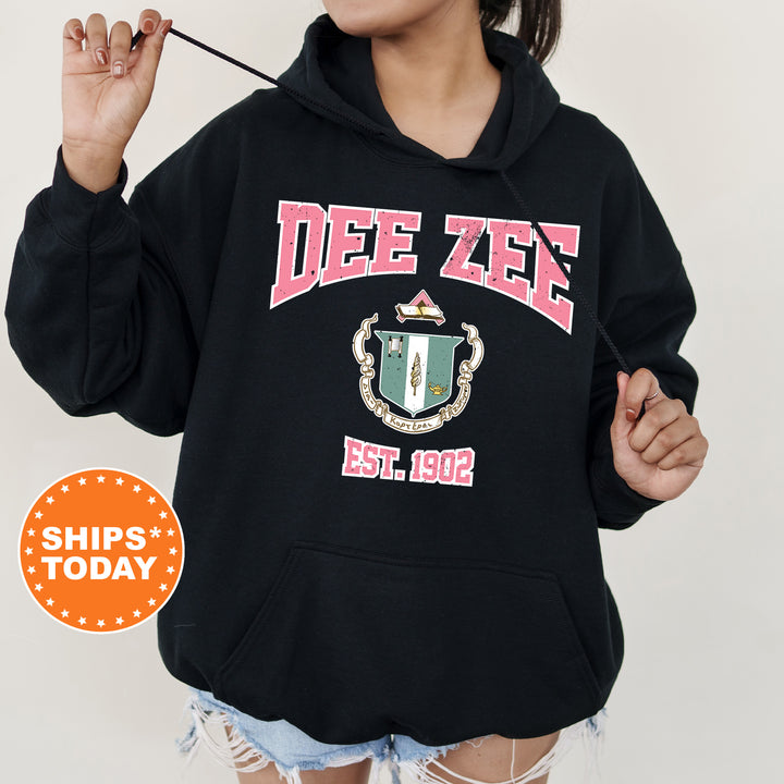 a woman wearing a black hoodie with a crest on it