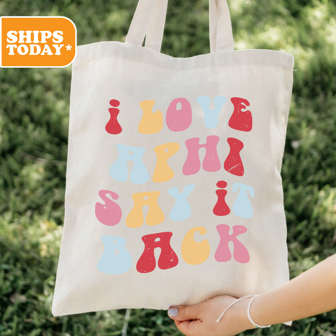 a person holding a tote bag with a message on it