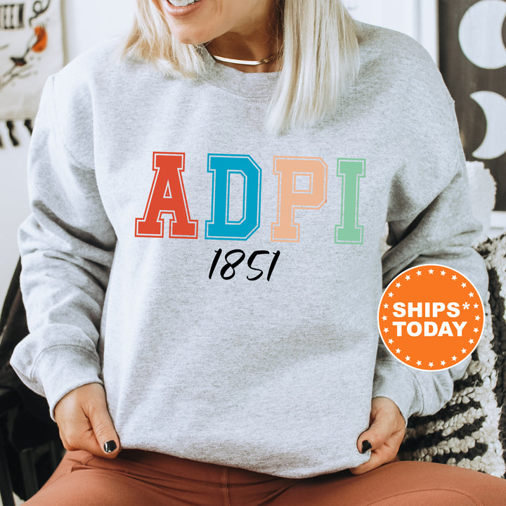 a woman sitting on a chair wearing a sweatshirt with the word adpi printed on