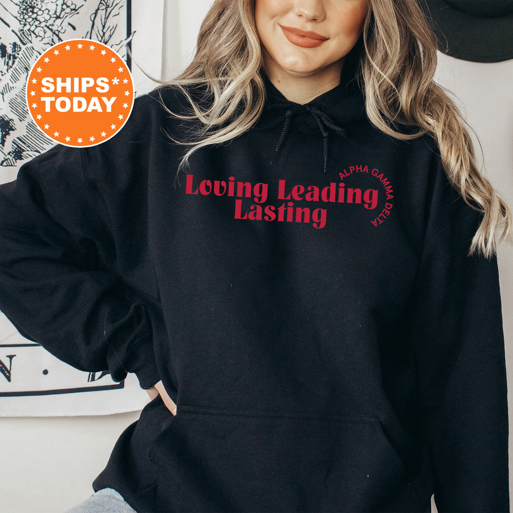 a woman wearing a black hoodie with a red print on it