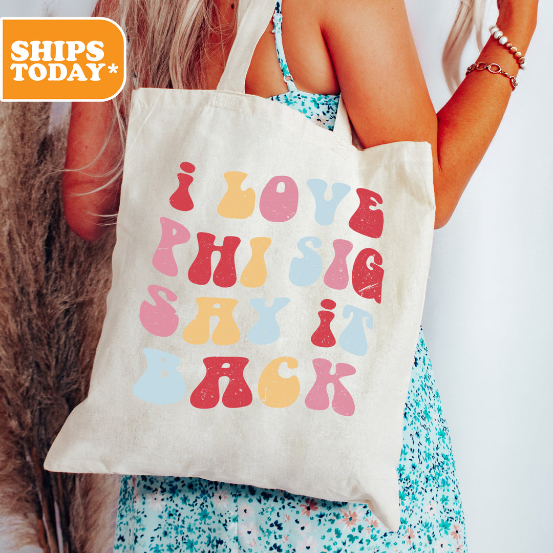 a woman holding a tote bag with a message on it