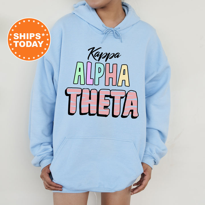 a person wearing a light blue hoodie with the words keep the alpha