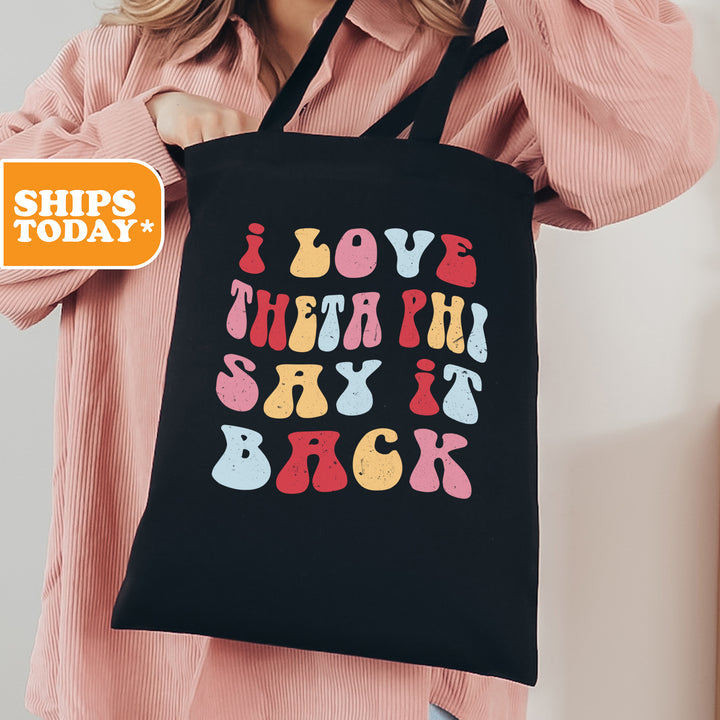 a woman holding a black shopping bag with the words love, teeth, and back