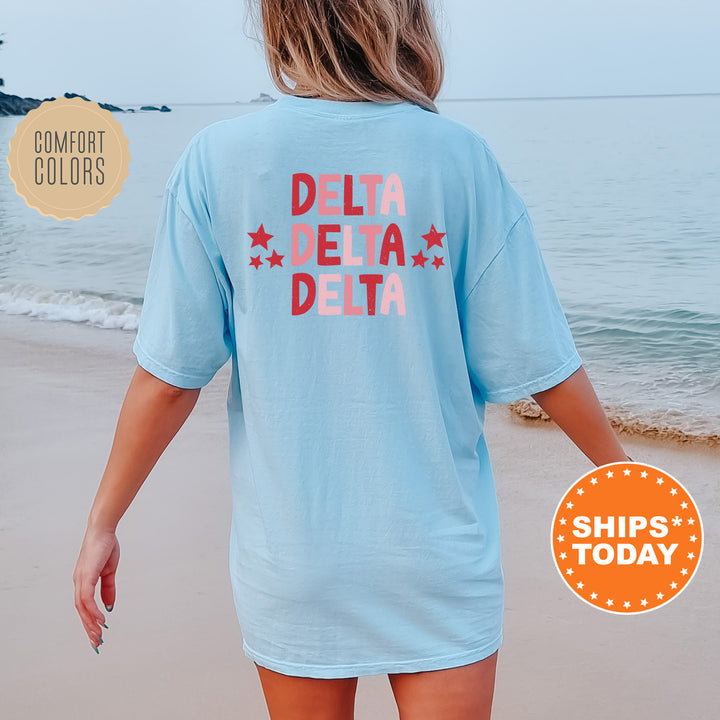 a woman walking on the beach wearing a t - shirt that says delta delta