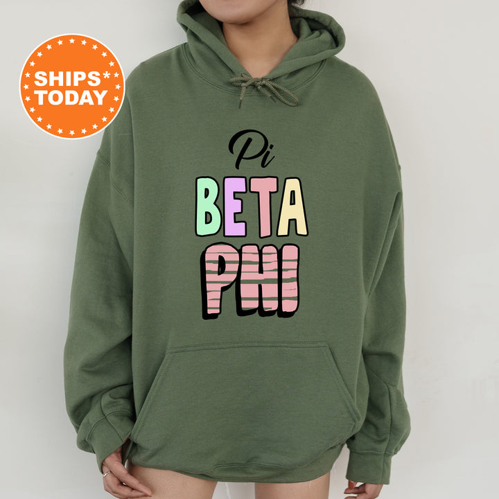 a woman wearing a green hoodie with the words beta phi printed on it