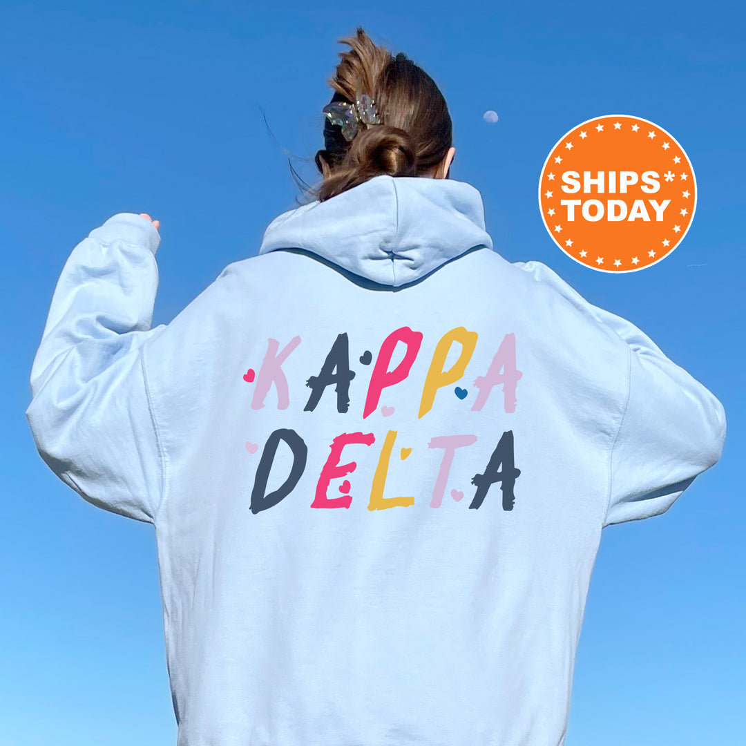 a woman wearing a white hoodie with the words kappa delta on it