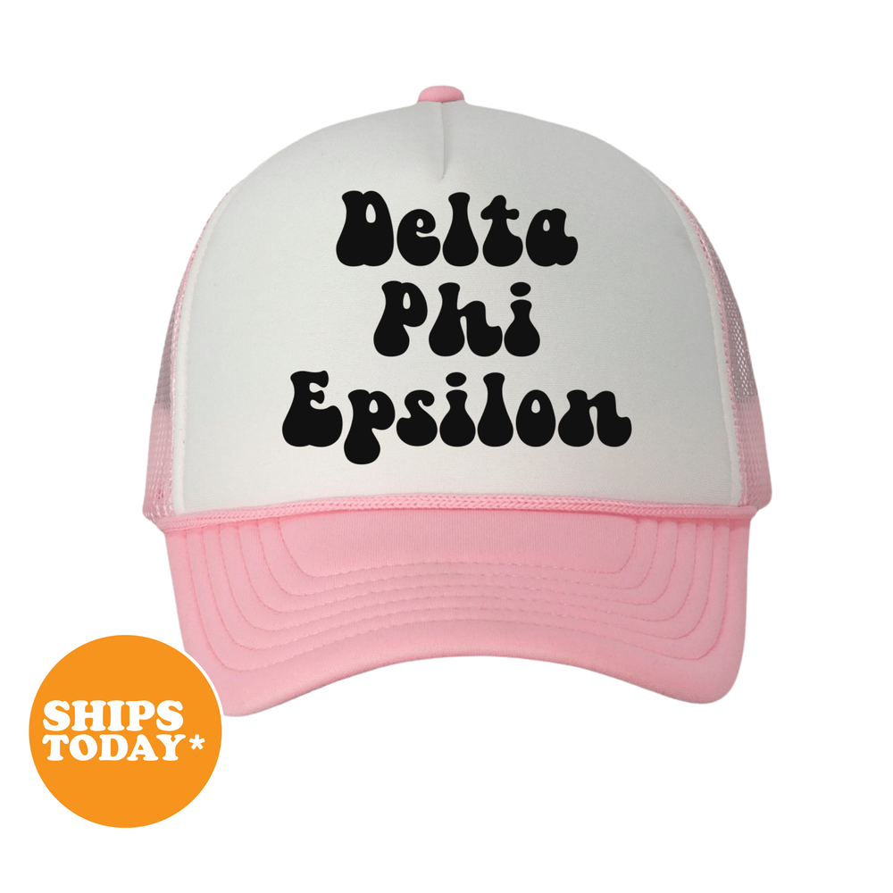 A white and pink baseball cap with the text "Delta Phi Epsilon" printed on it.