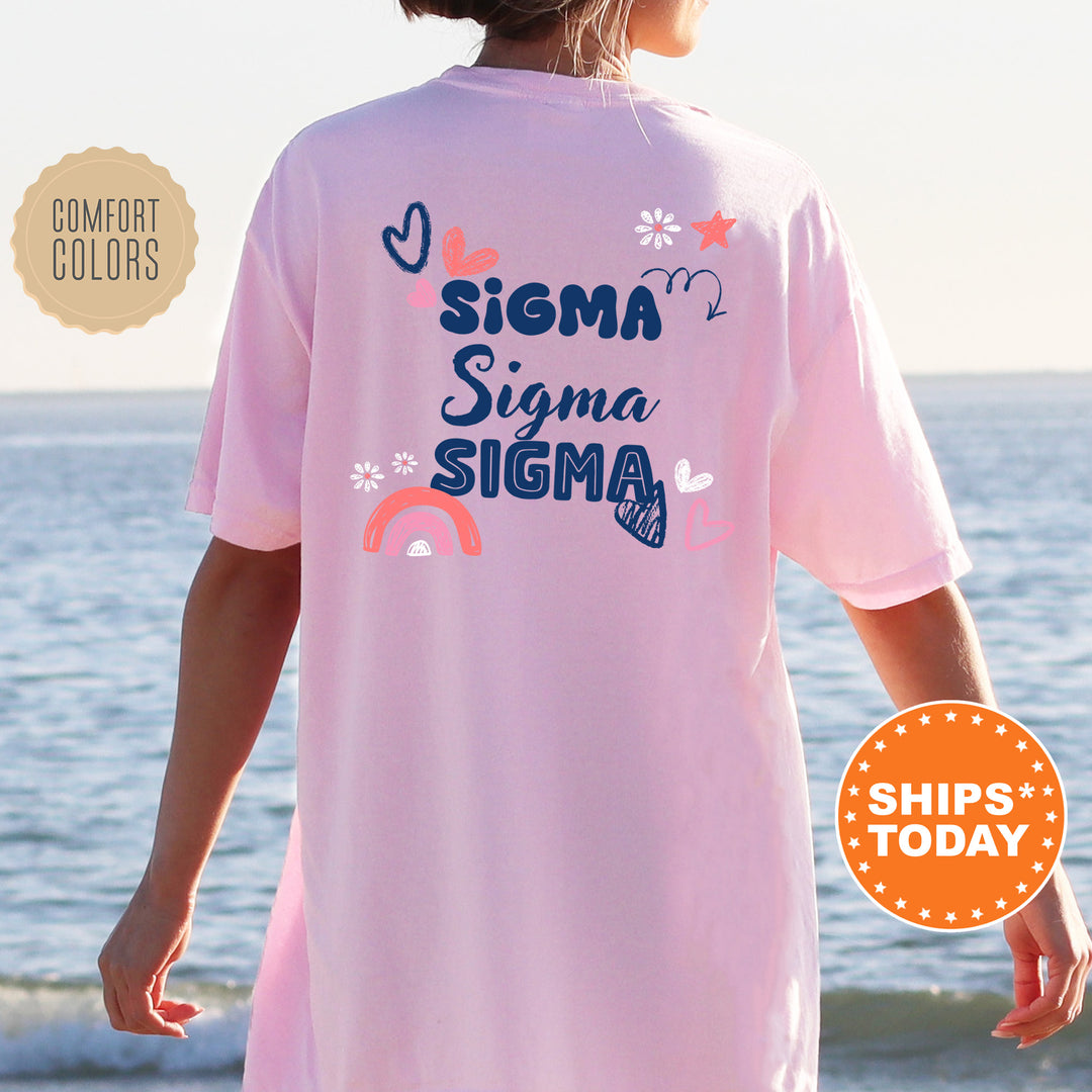 a woman standing on a beach wearing a pink shirt