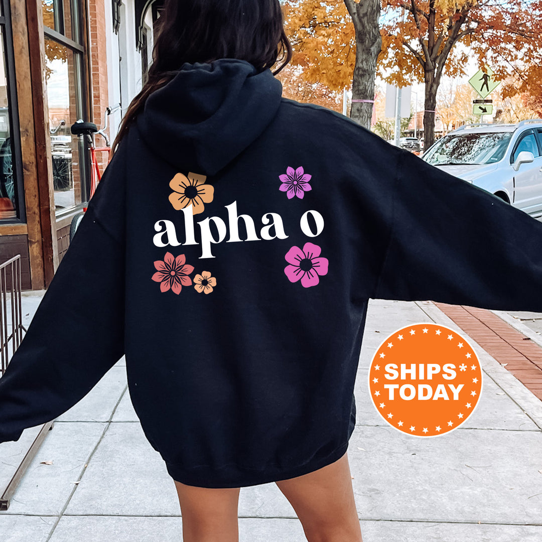 a woman walking down a sidewalk wearing a black hoodie